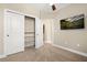 This bedroom features a ceiling fan, carpet, tv, closet, and neutral paint colors at 13618 Heaney Ave, Orlando, FL 32827