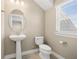 This half bathroom features neutral paint, a sink, a toilet, and tile flooring at 13618 Heaney Ave, Orlando, FL 32827