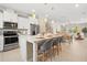 Open-concept kitchen featuring a large island with seating and stainless steel appliances at 13618 Heaney Ave, Orlando, FL 32827