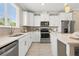 Bright kitchen featuring white cabinets, stainless steel appliances, and ample counter space at 13618 Heaney Ave, Orlando, FL 32827