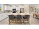 Modern kitchen boasts white cabinetry, stainless steel appliances, and a spacious center island at 13618 Heaney Ave, Orlando, FL 32827