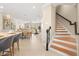 Bright open concept living area featuring stairs, dining, and kitchen in a modern setting at 13618 Heaney Ave, Orlando, FL 32827