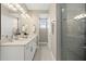 Modern main bathroom featuring double vanity, shower with glass door, and sleek fixtures at 13618 Heaney Ave, Orlando, FL 32827