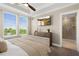 Bright main bedroom featuring a ceiling fan, large window with blind, and a door to the main bathroom at 13618 Heaney Ave, Orlando, FL 32827