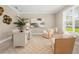Inviting home office featuring neutral tones, ample natural light, and comfortable seating at 13618 Heaney Ave, Orlando, FL 32827