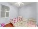 Cozy bedroom with hardwood floors, a ceiling fan, and two beds for children at 13768 Bluebird Pond Rd, Windermere, FL 34786