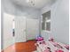 Bedroom with hardwood floors, a closet, and two doors, one leading to another room at 13768 Bluebird Pond Rd, Windermere, FL 34786