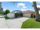 Garage with a driveway and a white gate leading to the screened-in pool at 13768 Bluebird Pond Rd, Windermere, FL 34786