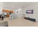 Open-concept living room with tile flooring, kitchen island with bar seating, and a media center at 13768 Bluebird Pond Rd, Windermere, FL 34786