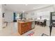 Open concept living room with tile floors, modern decor, and a breakfast bar at 13768 Bluebird Pond Rd, Windermere, FL 34786