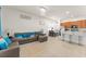 Bright and open living room with tile flooring, comfortable seating, and a kitchen with bar seating at 13768 Bluebird Pond Rd, Windermere, FL 34786