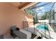 Enclosed patio with a screened-in pool, a safety fence, and outdoor seating at 13768 Bluebird Pond Rd, Windermere, FL 34786