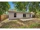 View of the back exterior features a sliding glass door leading to a patio and fenced backyard at 14565 Lycastle Cir, Orlando, FL 32826