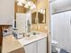 Bathroom features a white vanity, large mirror, and a shower with a white shower curtain at 14565 Lycastle Cir, Orlando, FL 32826