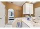 Bathroom boasts a white vanity with mirror, complemented by access to the bedroom through an arched doorway at 14565 Lycastle Cir, Orlando, FL 32826