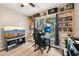 Comfortable bedroom with large window, ceiling fan, gaming setup and custom shelving at 14565 Lycastle Cir, Orlando, FL 32826