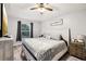 Cozy bedroom with wood-look flooring, a ceiling fan, and ample natural light at 14565 Lycastle Cir, Orlando, FL 32826