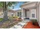 Welcoming front entrance with landscaped garden beds and a covered porch at 14565 Lycastle Cir, Orlando, FL 32826
