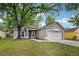 Charming single-story home featuring a well-maintained lawn and attached two-car garage at 14565 Lycastle Cir, Orlando, FL 32826