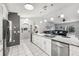 Open kitchen showcasing granite counters, stainless steel appliances, and an open floor plan to the living area at 14565 Lycastle Cir, Orlando, FL 32826
