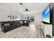 Inviting living area with sleek flooring, a large sectional, and ample natural light at 14565 Lycastle Cir, Orlando, FL 32826