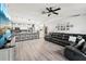 Open-concept living room featuring a ceiling fan and modern flooring, great for Gathering gatherings at 14565 Lycastle Cir, Orlando, FL 32826