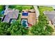 Aerial view of the home with a pool and solar panels at 14723 Pine Cone Trl, Clermont, FL 34711