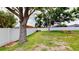 An expansive backyard featuring a privacy fence, mature trees, and a fire pit is perfect for outdoor activities at 14723 Pine Cone Trl, Clermont, FL 34711