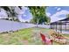 A spacious backyard with a well-maintained lawn, privacy fence, and cozy fire pit provides ample outdoor enjoyment at 14723 Pine Cone Trl, Clermont, FL 34711
