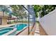 A luxurious backyard pool and spa create a serene retreat, complemented by lush greenery and a screened enclosure at 14723 Pine Cone Trl, Clermont, FL 34711