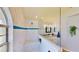 Bathroom features a marble-tiled walk-in shower with a glass partition and a sink with granite counters at 14723 Pine Cone Trl, Clermont, FL 34711