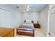 Bedroom with a cozy bed, ceiling fan, and ample space for furniture at 14723 Pine Cone Trl, Clermont, FL 34711