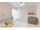 Bedroom with neutral walls, white trim and a tiled floor at 14723 Pine Cone Trl, Clermont, FL 34711