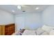 Well-lit bedroom features a ceiling fan and a dresser at 14723 Pine Cone Trl, Clermont, FL 34711