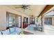 A covered patio with a cozy seating area, fireplace, and access to the pool offers the perfect outdoor living space at 14723 Pine Cone Trl, Clermont, FL 34711