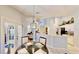 Dining room with elegant chandelier lighting and french door view of the pool at 14723 Pine Cone Trl, Clermont, FL 34711