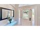Elegant entryway with decorative glass door, sidelights, mirror, and console table at 14723 Pine Cone Trl, Clermont, FL 34711