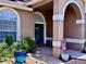 Charming front porch with a fountain, seating, and lush landscaping at 14723 Pine Cone Trl, Clermont, FL 34711