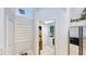 Hallway featuring laundry room, pantry, and stainless steel refrigerator at 14723 Pine Cone Trl, Clermont, FL 34711