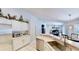 Open-concept kitchen with stainless steel appliances, counter seating, and views to the dining area at 14723 Pine Cone Trl, Clermont, FL 34711