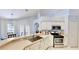 Bright kitchen with stainless steel appliances, plenty of counter space and white cabinetry at 14723 Pine Cone Trl, Clermont, FL 34711
