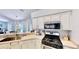 Modern kitchen with white cabinets, stainless steel appliances, and a view to the outdoor pool at 14723 Pine Cone Trl, Clermont, FL 34711
