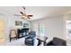Bright living room features tile floors, ceiling fan, and glass doors leading to the pool area at 14723 Pine Cone Trl, Clermont, FL 34711