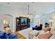 Bright living room boasts vaulted ceilings, a ceiling fan, an entertainment center, and comfortable seating at 14723 Pine Cone Trl, Clermont, FL 34711