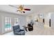 An open-concept living space with tile floors, access to the pool and patio, and a view of the kitchen and dining area at 14723 Pine Cone Trl, Clermont, FL 34711