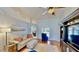 Cozy living room with a comfortable sofa, wooden floors, and an entertainment center at 14723 Pine Cone Trl, Clermont, FL 34711