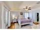 Relaxing main bedroom with hardwood floors, a ceiling fan, and a decorative four-poster bed at 14723 Pine Cone Trl, Clermont, FL 34711