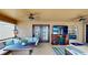 Covered patio with a ceiling fan, TV, and French doors at 14723 Pine Cone Trl, Clermont, FL 34711