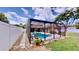A screened-in pool in the backyard with chairs and potted plants at 14723 Pine Cone Trl, Clermont, FL 34711
