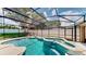 Relaxing pool with spa surrounded by a screen enclosure for year-round enjoyment at 14723 Pine Cone Trl, Clermont, FL 34711